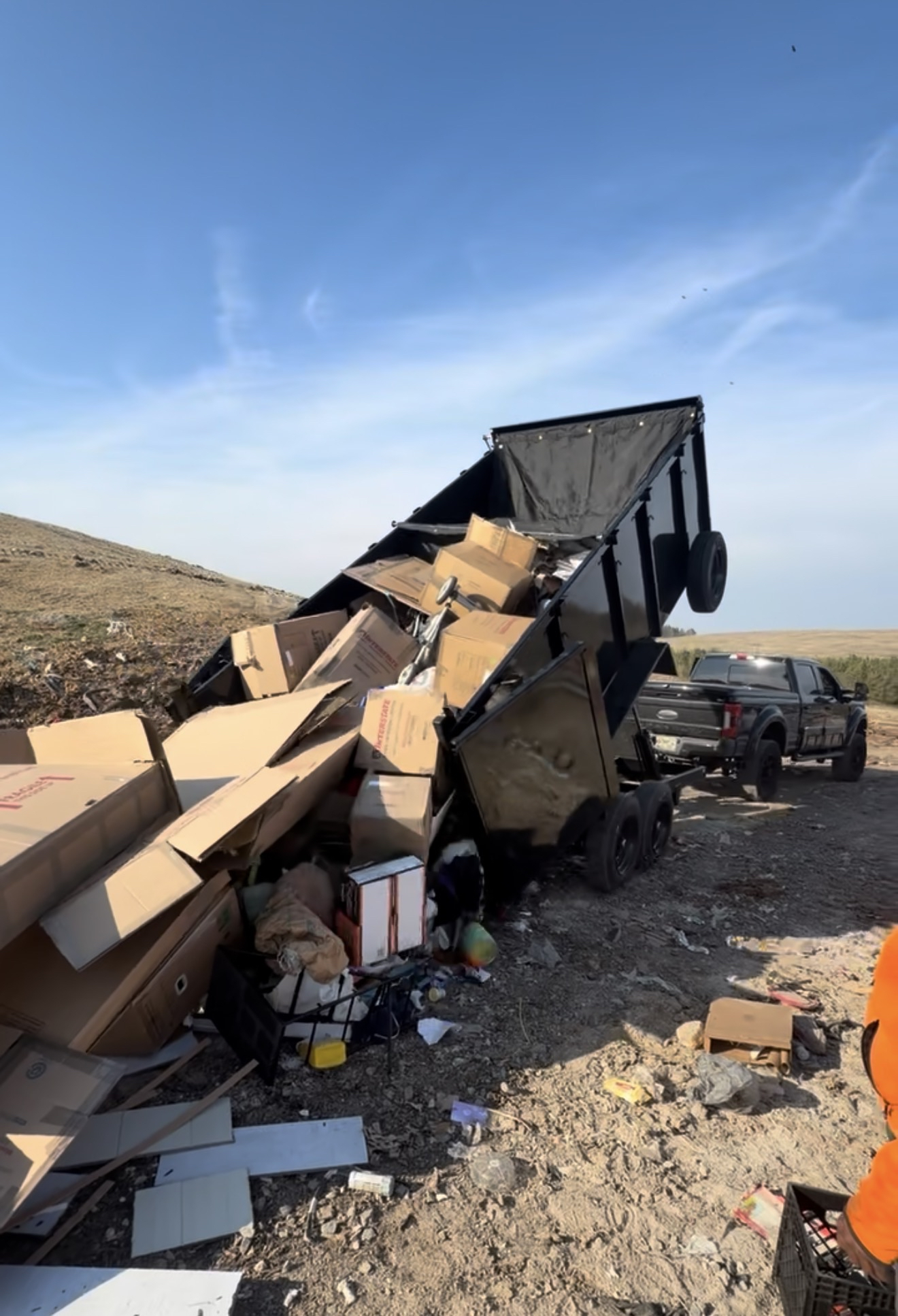 Dump trailer unloading junk at the landfill