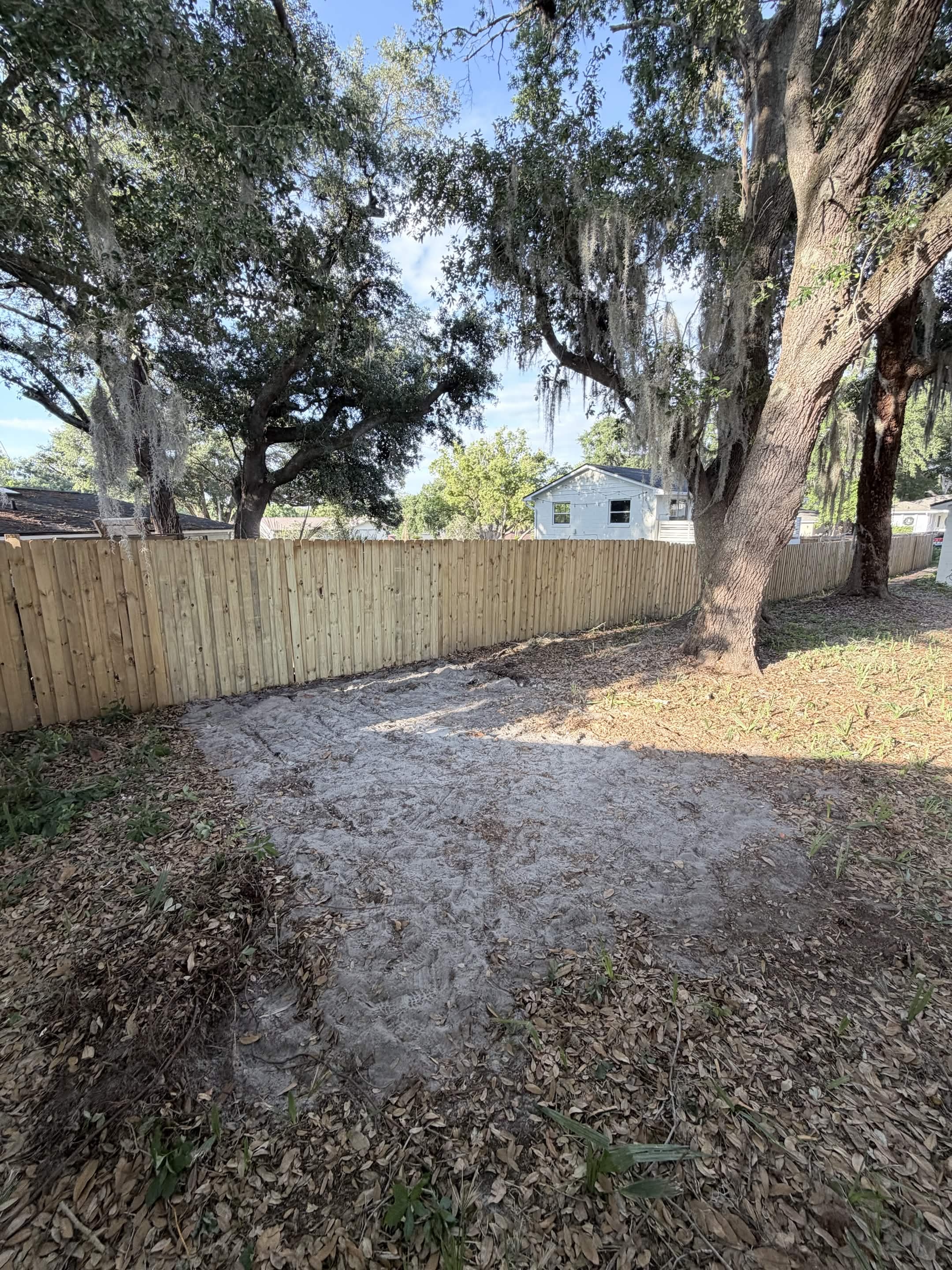 Cleared backyard with new fence after Aventis junk removal and yard cleanup in Kissimmee, FL