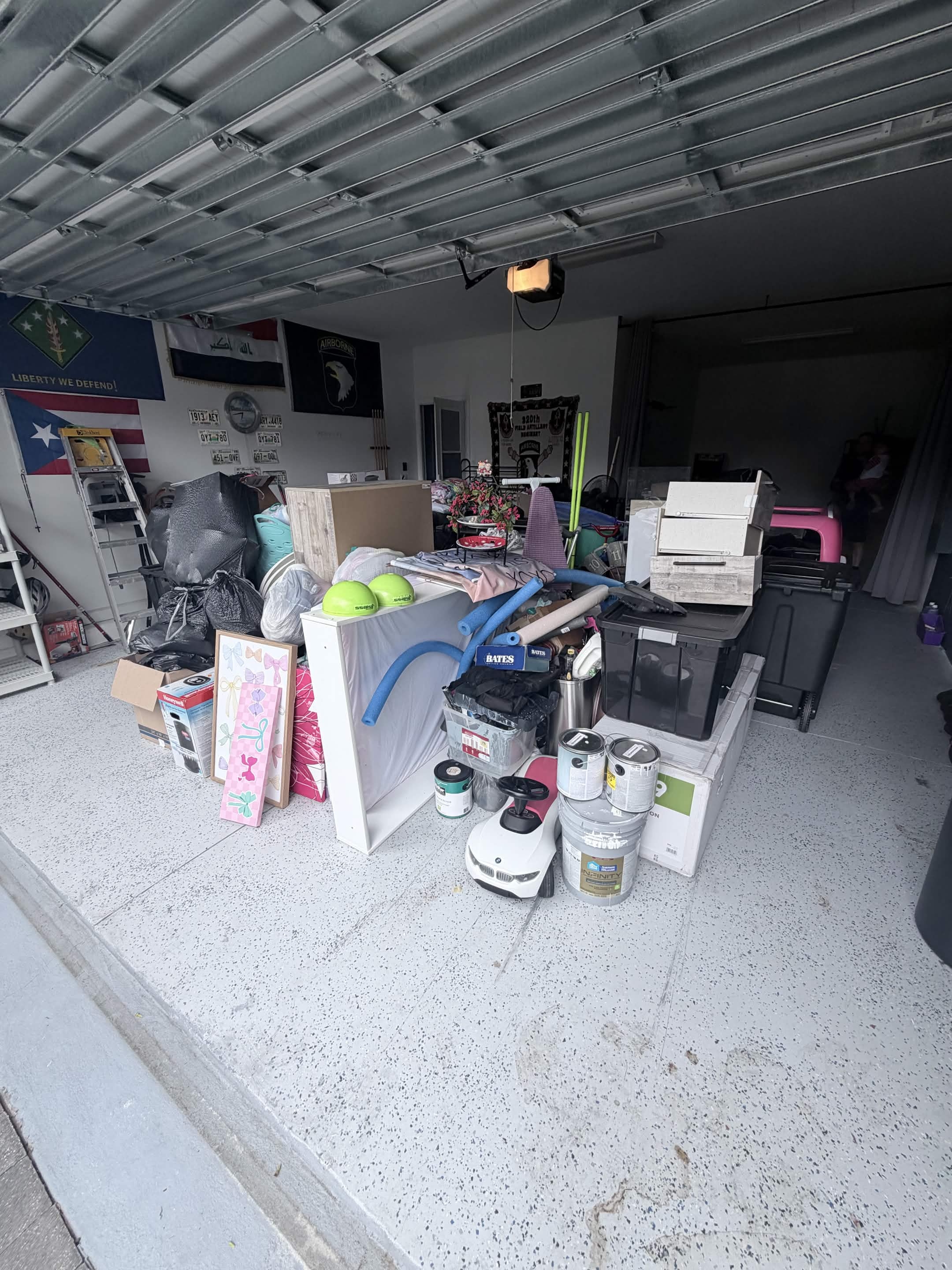 Cluttered garage before a full cleanout by Aventis Junk Removal in Kissimmee, FL