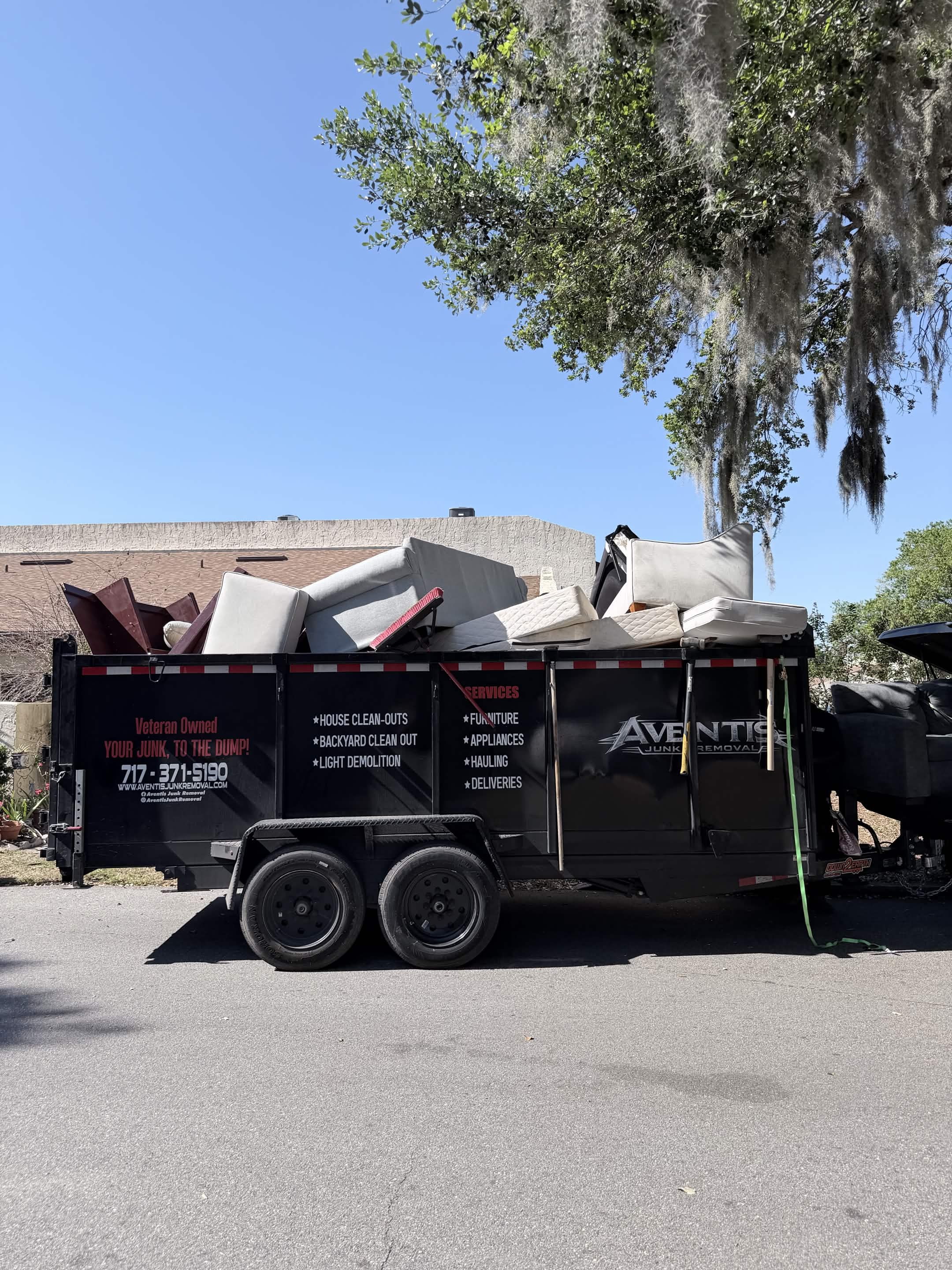 Aventis trailer loaded with mattresses and furniture from a Kissimmee, FL house cleanout