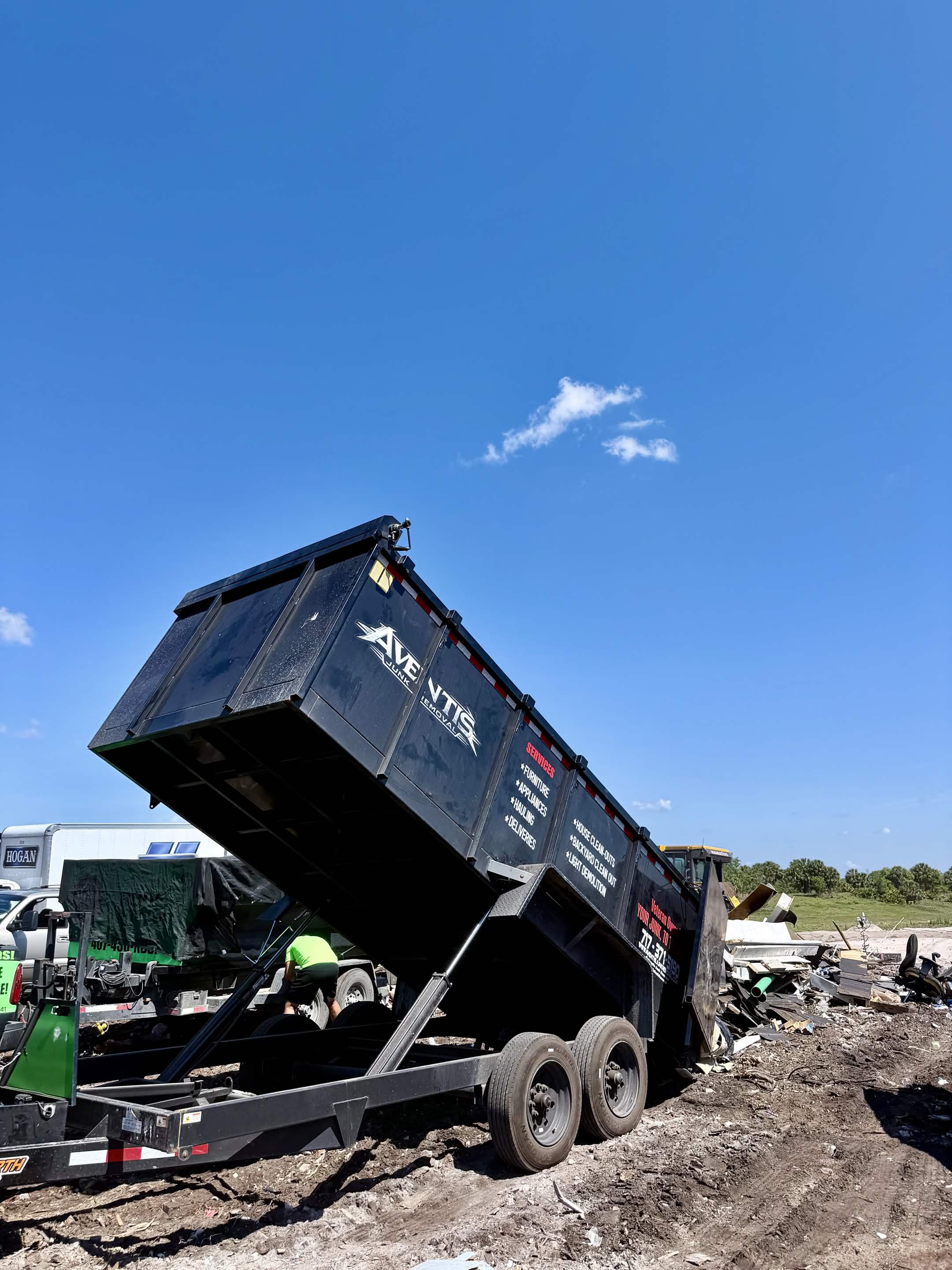 Aventis Junk Removal dump trailer unloading a full load at the landfill near Kissimmee, FL